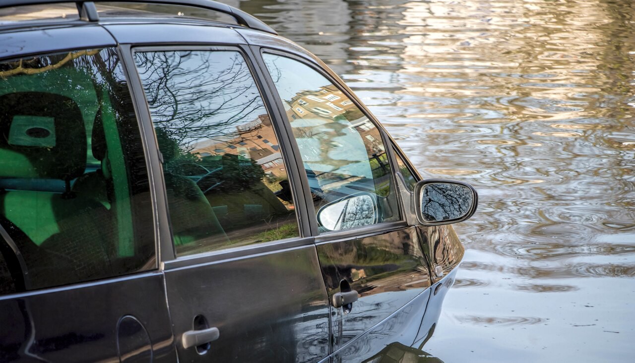 A car half submerged in a body of water.