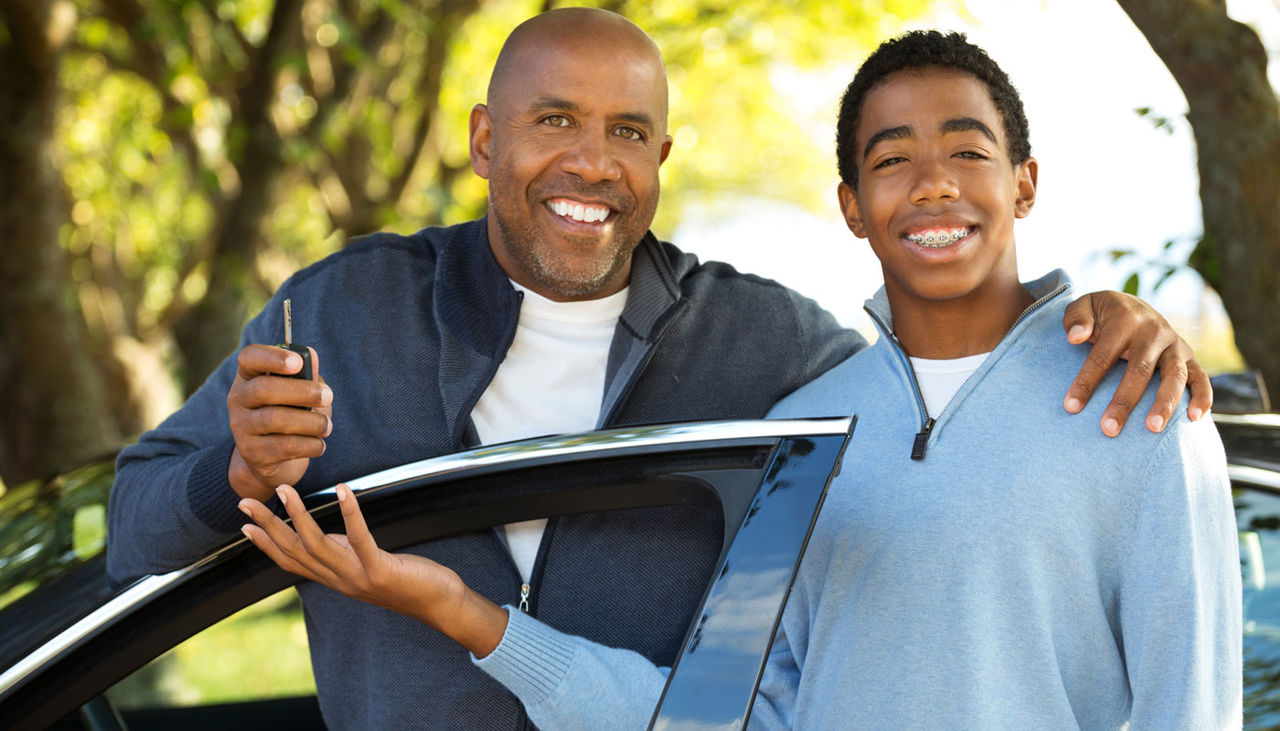 Father teaching his son how to drive.
